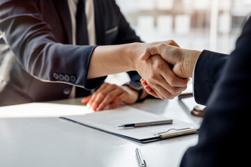 Businessmen making handshake in the city - business etiquette, congratulation, merger and acquisition concepts, panoramic banner