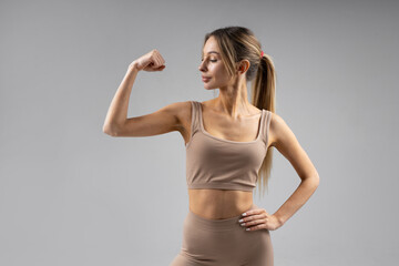 strong hand gesture of caucasian beautiful female in sportswear 