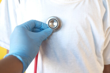 Fototapeta premium Doctor using a stethoscope checking child body, close up