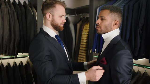 In a luxury tailoring atelier the designer man wear the suit on his client the client wear the handmade suit concept of fashion design and handmade suits
