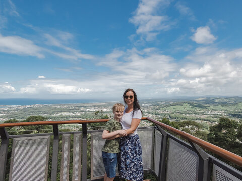 Mother and son posing for photo on the Forest Sky Pier at Sealy Lookout, Coffs Harbour Australia