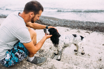 Happy owner of russian cocker spaniel dog, responsibility of caring about pet
