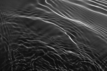 Soft focus lite purple pink rose cosmetic moisturizer floral water, micellar toner, or emulsion abstract background. Reflections of  scattered sun texture.