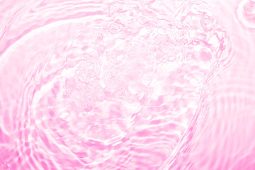 Soft focus lite purple pink rose cosmetic moisturizer floral water, micellar toner, or emulsion abstract background. Reflections of  scattered sun texture.