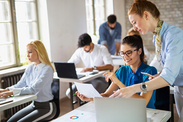 Portrait of creative business people team working together and smiling in office.