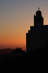 Obraz premium A Greek Orthodox Church and a Greek national flag in Santorini