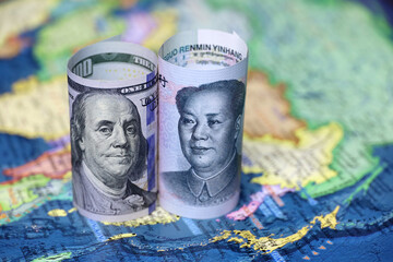 Chinese yuan and US dollars on the map of China. Concept of political conflict over Taiwan - obrazy, fototapety, plakaty