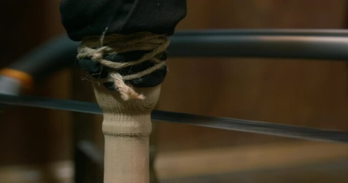 Pirate captain wooden leg prosthesis sawed with sharp blade on blurred background IN semi-dark ship cabin during voyage closeup