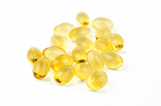 Yellow capsules close-up. Capsules with fish oil or vitamin 3d, selective focus