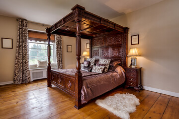 victorian rectory bedroom with ornate carved four poster bed - obrazy, fototapety, plakaty