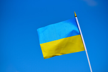 Close-up flag of Ukraine on blue sky background,national blue and yellow flag photo, patriot of Ukraine sign
