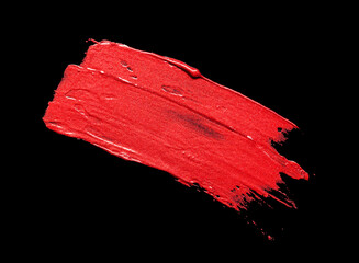Lipstick red metallic colored smudged on black isolated background