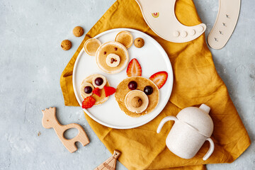 Animal Shaped Pancake with strawberry and fruit for kids. Plate with funny pancake. Funny breakfast idea for children. Kids meal. Flat Lay - 493027844