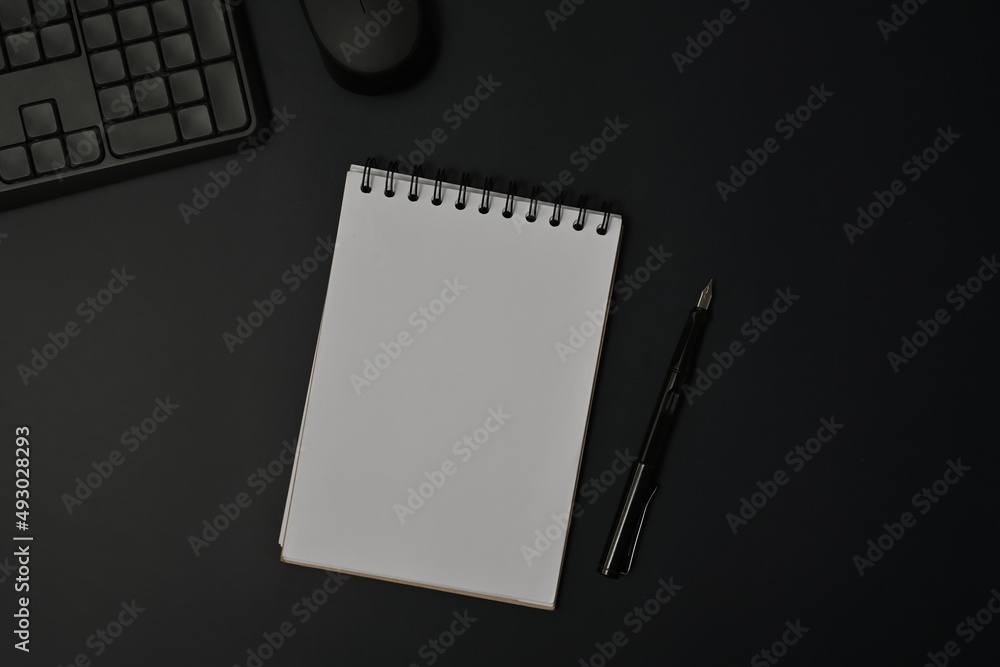 Poster top view with working space decorated by keyboard, mouse and note paper and pen on the black backgro