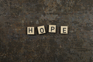 "hope" phrase on a brown ceramic background