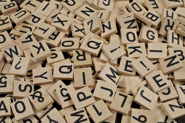 pile of wooden tiles with latin alphabet letters and characters