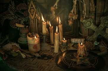 Candle burns on the altar, powerful magic among candles, pagan or wicca concept - obrazy, fototapety, plakaty