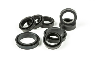 Fototapeta premium A rubber ring - a gasket, an oil seal for repairing a car brake caliper on a plane. Set of spare parts for car brake repair. Details on white background, copy space available.