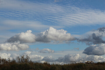 Summer Landscape. Blue sky with clouds. At the beautiful beach near the coastline of the blue Baltic sea in Latvia. Beautiful background.