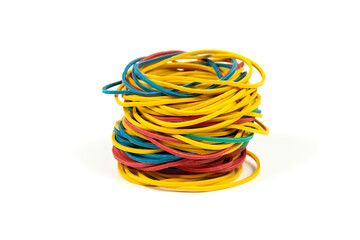 Colored rubber bands for money stacked in a high pile against white background