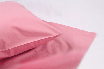 Corner of a soft pillow in a new colored cotton fiber pillowcase. Satin  material to protect and...