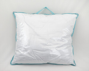 White pillow in a plastic bag with a carrying handle. Mock up template to place any label and insert. Textile product packaged for sale