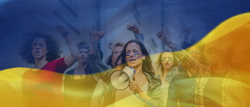 Double exposure of crowd of activists protesting against Russian military invasion in Ukraine walking in street and Ukrainian flag.