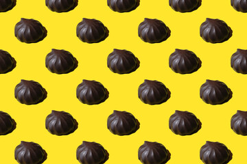 pattern of marshmallows in chocolate. Repeating Chocolate covered marshmallows on yellow background