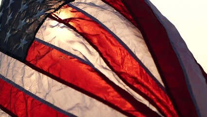 American flag waving against sunset in nature background, slow Motion. Concept of Memorial Day, 4th of July, Independence Day, Veterans Day, National American Celebration, Patriots, Labor, President.