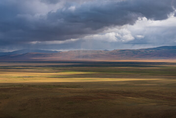 steppe mountains rain clouds sunlight sunset