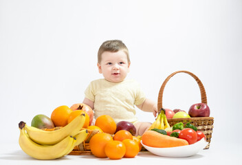 Cute baby boy sitting with fruits and vegetables isolated on white background healthy food feed baby