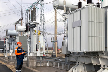 Electrical substation engineer inspects modern high-voltage equipment. Energy. Industry