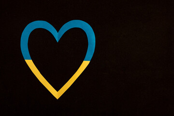 Ukraine heart on a black background. Heart with the national flag of Ukraine. Russia war in Ukraine