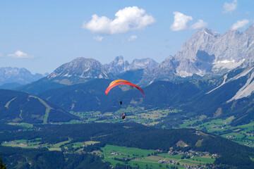 friends paragliding in the Alps of the Dachstein region in Austria	