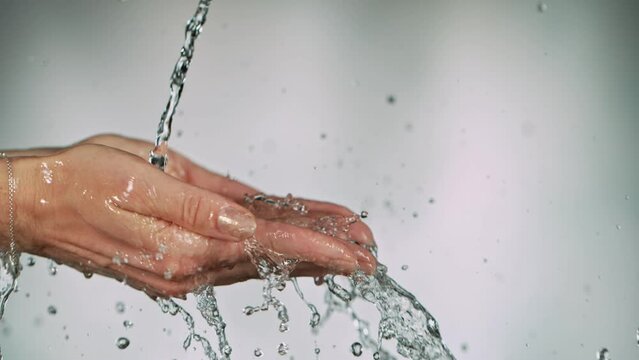 Fresh water splashing on womans hands, super slow motion filmed at 1000 fps.