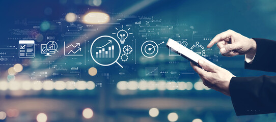 Data Analysis concept with businessman using a tablet computer