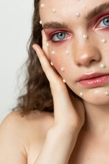 Beauty portrait of a beautiful girl with an unusual appearance, makeup in the studio.