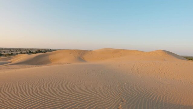 4K Shot of Khuri sand dunes in the morning at Thar desert at Jaisalmer in Rajasthan, India. View of the sand dunes in the desert. Desert background.