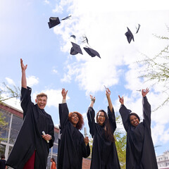 Woohoo Bring it on. Low angle shot of student throwing their graduation hats into the air.