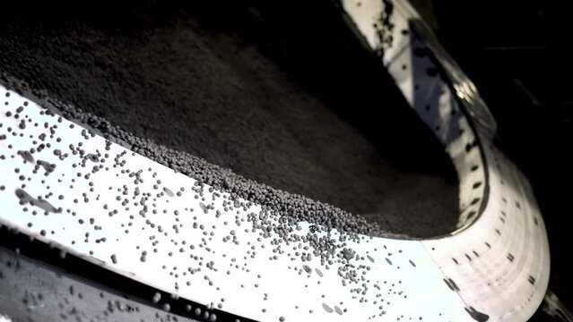 Production of iron ore pellets in pelletizer bowls. Part of the technological process for the processing of minerals. Raw material for metallurgy.