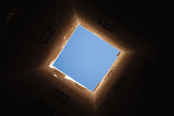 Square light window in dark tower interior