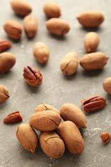 Pecan nuts on a grey table. Vertical photo.