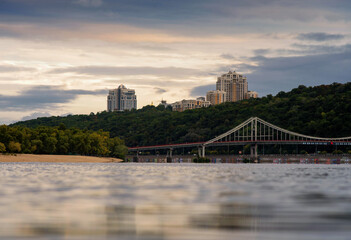 Kyiv. Dnipro, bridge and hills of the historical city under the sunset sky