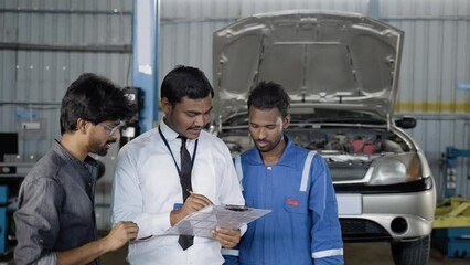 Customer discussing with Mechanic and garage executive about car problems during repair or maintenance service - concept of customer communication and employee conversation - Powered by Adobe