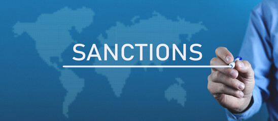 Man writes Sanction word in screen. - obrazy, fototapety, plakaty