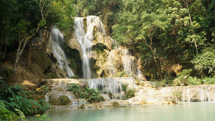 Fototapeta na wymiar Kuang Si Waterfall in tropical rainforest setting in Laos.