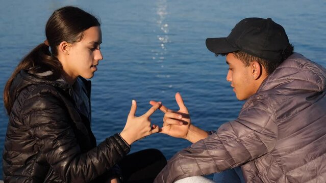 Romantic young couple doing hand tricks and kiss near sea relationships