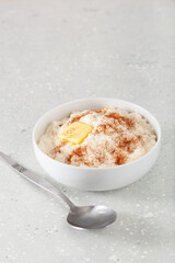 rice pudding with butter cinnamon. french riz au lait, norwegian risgrot, traditional breakfast dessert
