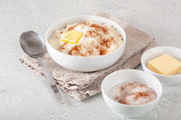 rice pudding with butter cinnamon. french riz au lait, norwegian risgrot, traditional breakfast dessert