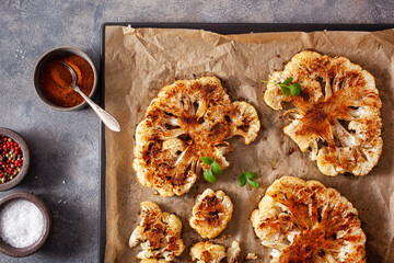 cauliflower steaks with herb sauce and spice. plant based meat substitute